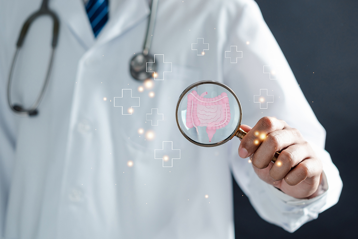 A physician with a magnifying glass on the digestive tract depicting a problem with Leaky Gut, which can be treated at Maumee Integrated Health